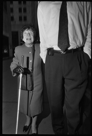 USA. New York City. 1992. Blind woman guided through 57th Street.