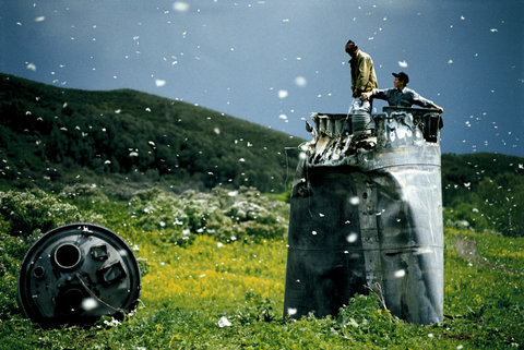 RUSSIA. Altai Territory. 2000. Villagers collecting scrap from a crashed spacecraft, surrounded by thousan